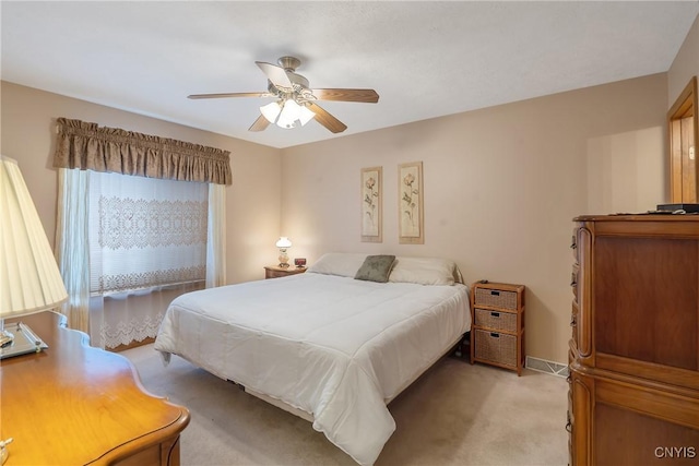 bedroom featuring ceiling fan and light colored carpet