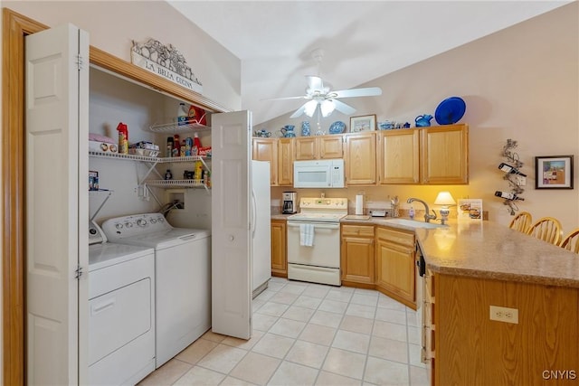 kitchen featuring washer and dryer, white appliances, sink, kitchen peninsula, and light tile patterned floors