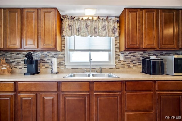 kitchen featuring decorative backsplash and sink