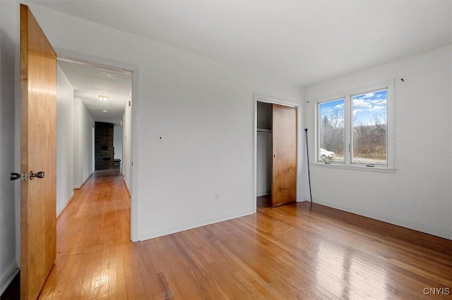 unfurnished bedroom with a closet and light hardwood / wood-style flooring