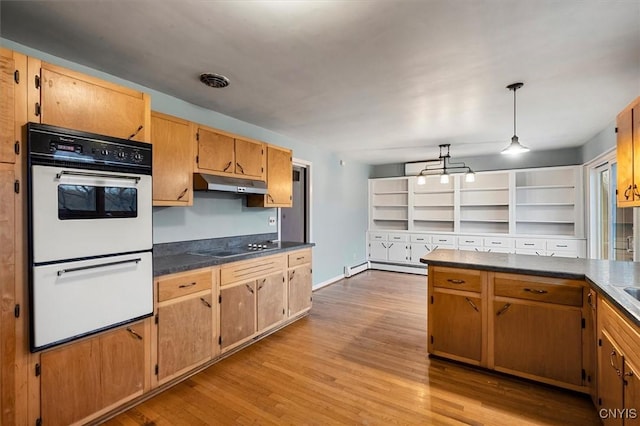 kitchen featuring light wood-type flooring, black electric stovetop, double oven, pendant lighting, and a baseboard heating unit