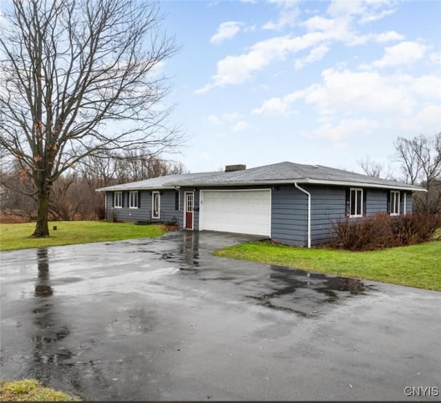 ranch-style home with a front lawn and a garage