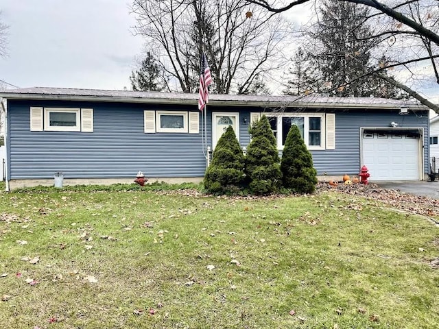 single story home featuring a garage and a front lawn