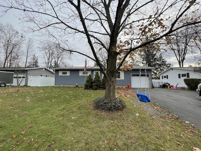 view of front of property with a front lawn and a garage