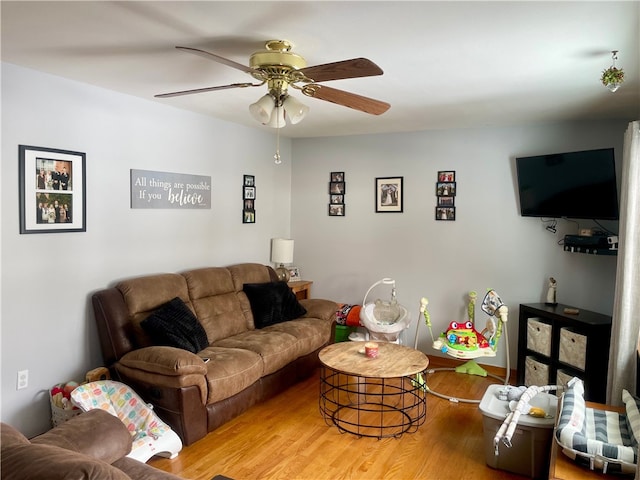 living room with ceiling fan and hardwood / wood-style flooring