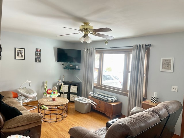 living room featuring light wood-type flooring and ceiling fan