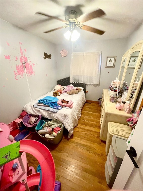 bedroom featuring ceiling fan and light hardwood / wood-style flooring