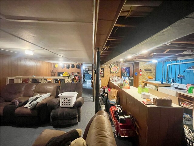 basement with washer / dryer and wooden walls