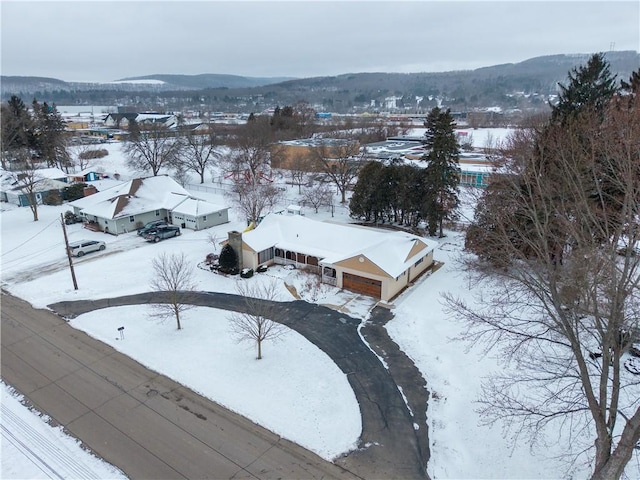 snowy aerial view with a mountain view