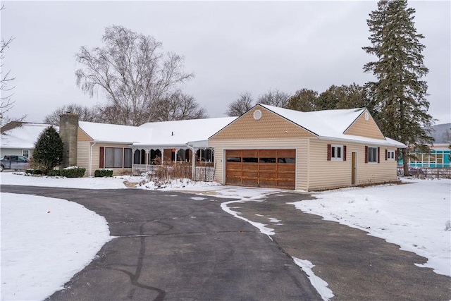 ranch-style house with a porch and a garage