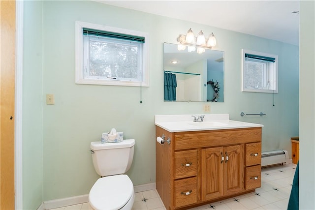 bathroom with toilet, vanity, a baseboard heating unit, and a wealth of natural light