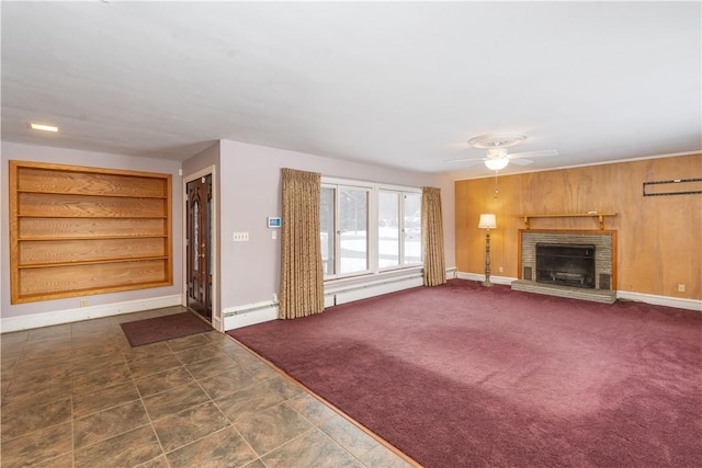 unfurnished living room with ceiling fan, dark colored carpet, a fireplace, and a baseboard heating unit