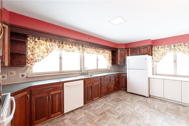 kitchen featuring white appliances and sink