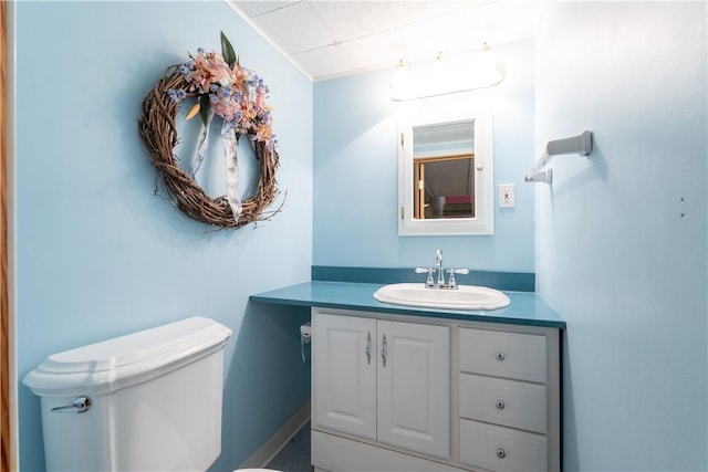 bathroom featuring toilet and vanity