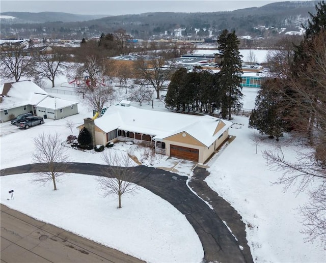 snowy aerial view with a mountain view