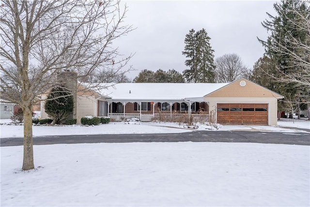 single story home with covered porch and a garage