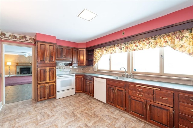 kitchen with white appliances, tasteful backsplash, ventilation hood, and sink