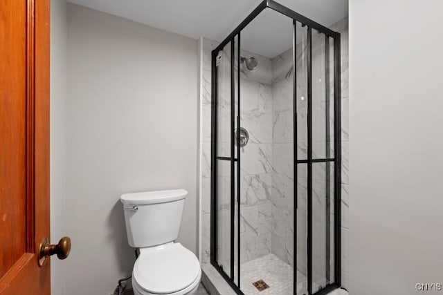 bathroom with toilet and a shower with shower door