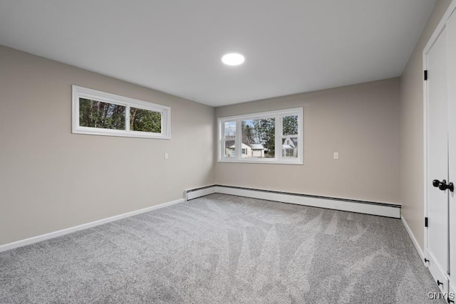 spare room featuring a baseboard radiator and carpet flooring