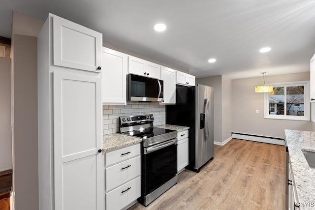 kitchen featuring baseboard heating, stainless steel appliances, light stone counters, white cabinets, and decorative light fixtures