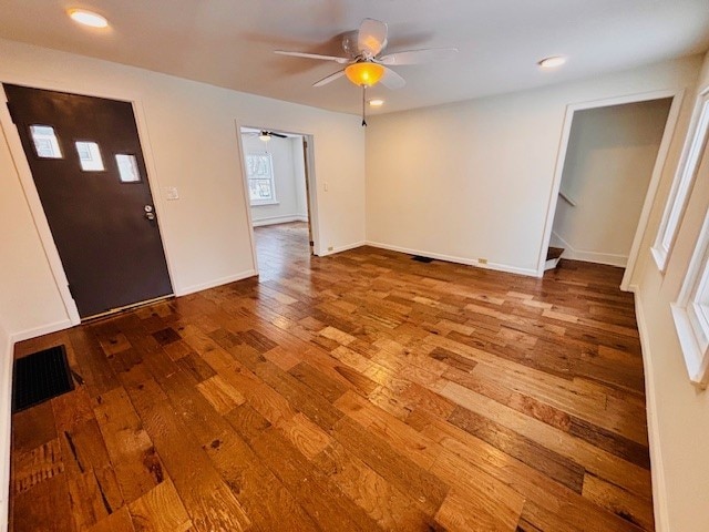 foyer entrance with ceiling fan and hardwood / wood-style floors