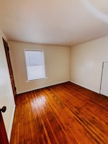 spare room with hardwood / wood-style flooring