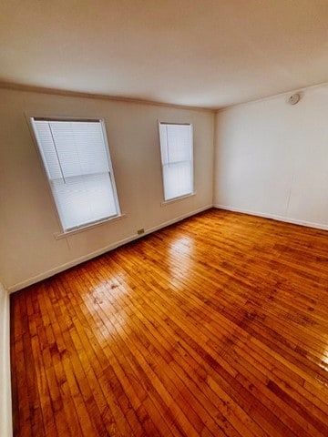 unfurnished room with wood-type flooring