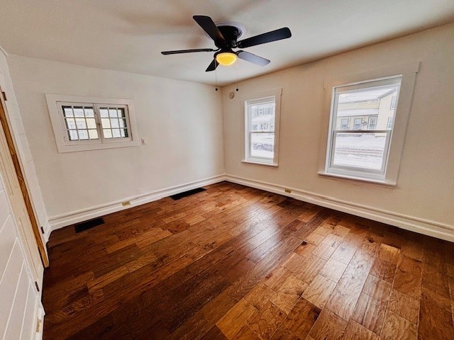 empty room with ceiling fan and hardwood / wood-style flooring