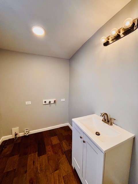 laundry room featuring sink, dark wood-type flooring, and washer hookup