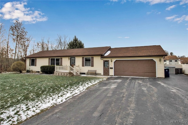 single story home with a front yard and a garage