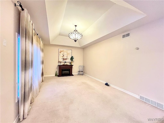 interior space featuring a notable chandelier and a tray ceiling