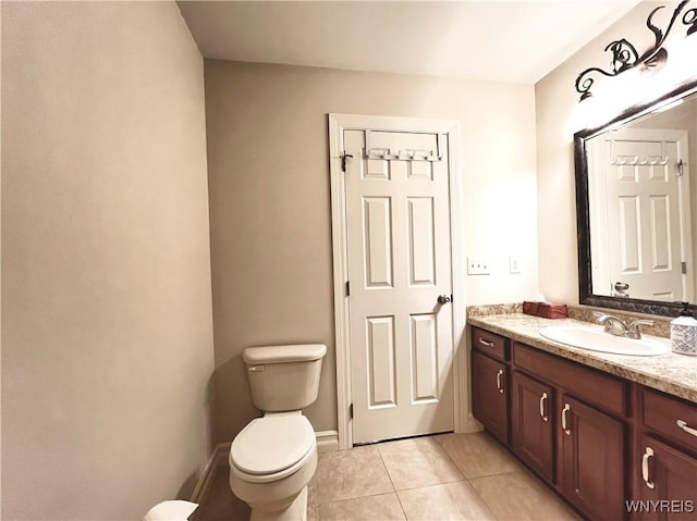 bathroom featuring toilet, vanity, and tile patterned floors