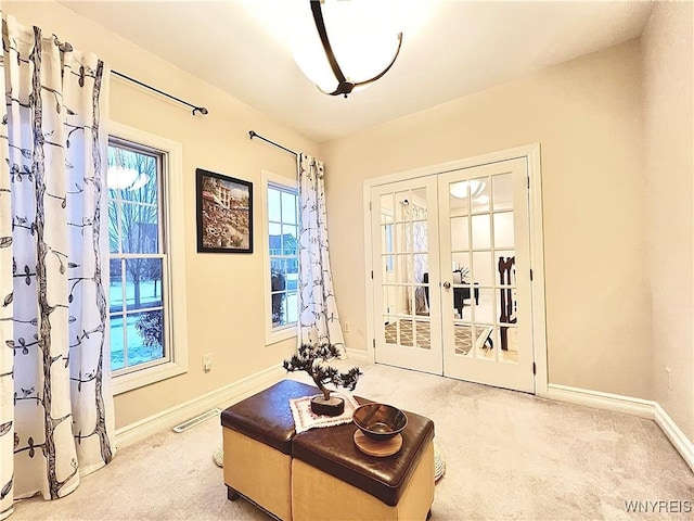 living area with carpet floors and french doors