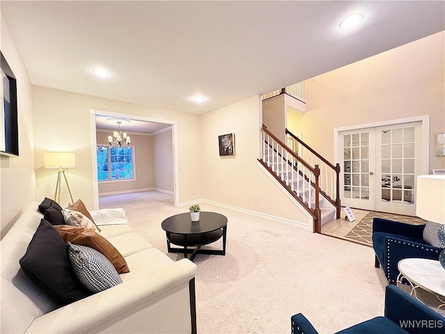 living room with ornamental molding, french doors, an inviting chandelier, and light carpet