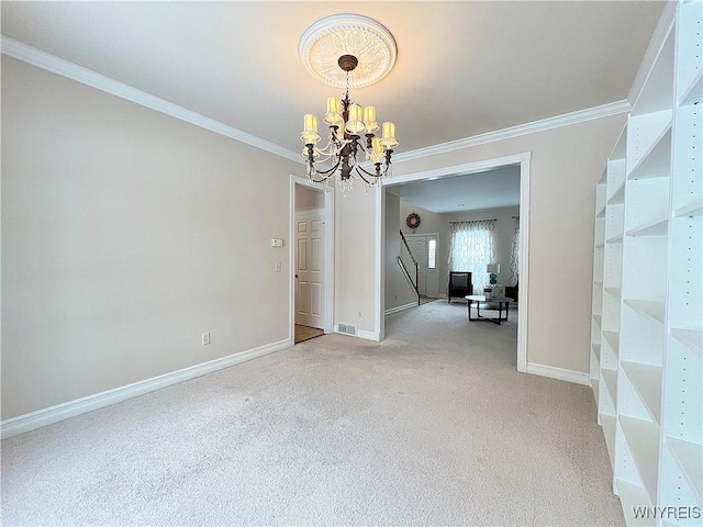 spare room featuring a notable chandelier, crown molding, and carpet