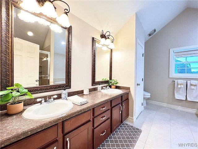 bathroom featuring toilet, lofted ceiling, tile patterned floors, a shower with shower door, and vanity