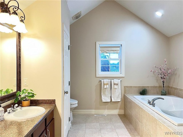 bathroom featuring tile patterned flooring, lofted ceiling, vanity, and toilet