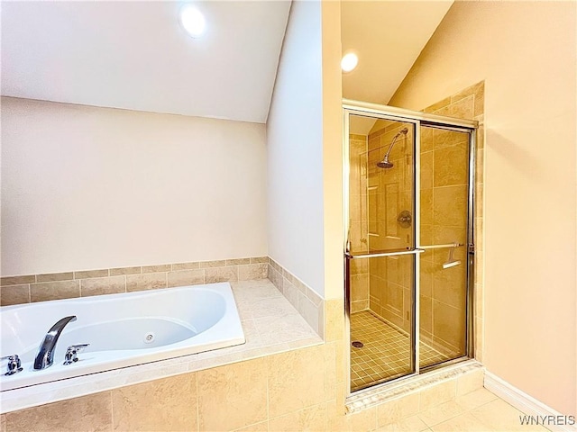 bathroom with separate shower and tub, tile patterned flooring, and lofted ceiling