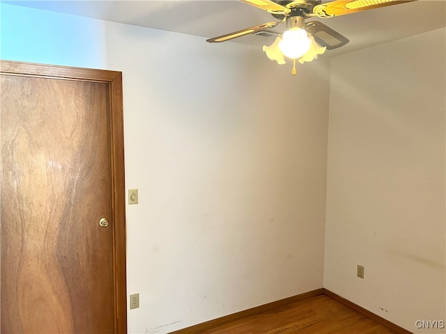 empty room featuring wood-type flooring and ceiling fan