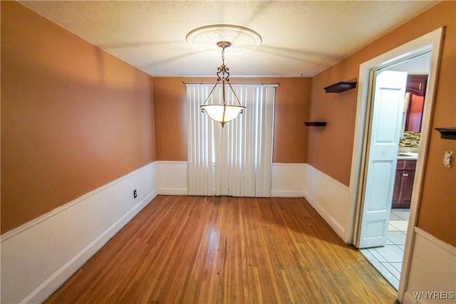 unfurnished dining area featuring light hardwood / wood-style flooring