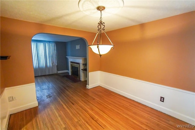 unfurnished dining area featuring wood-type flooring