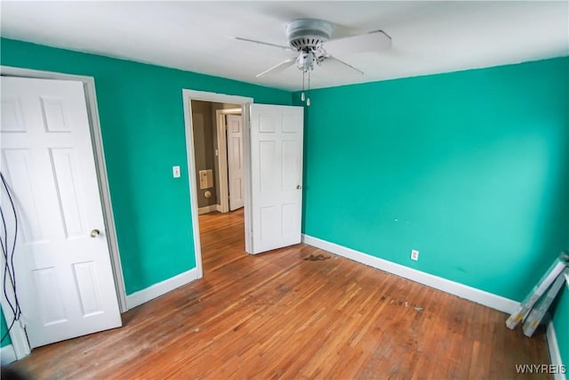 unfurnished bedroom featuring ceiling fan and hardwood / wood-style floors