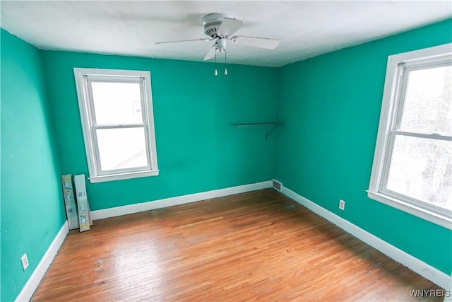 spare room featuring ceiling fan and hardwood / wood-style floors