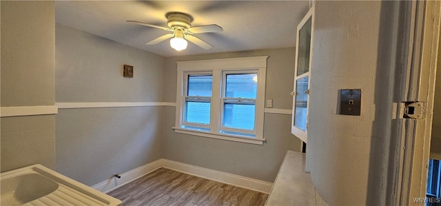 interior space with wood-type flooring and ceiling fan