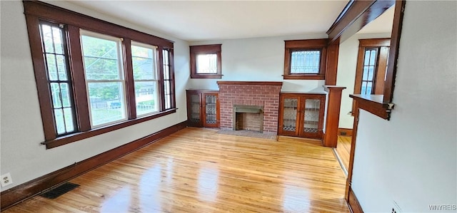 living room with a fireplace and light hardwood / wood-style floors