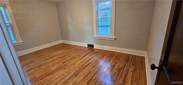 unfurnished room with hardwood / wood-style flooring