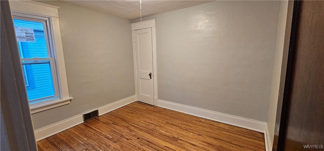 unfurnished room featuring hardwood / wood-style flooring