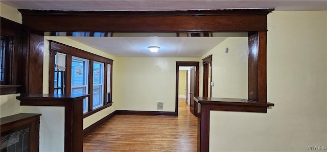 corridor featuring light hardwood / wood-style floors and a wealth of natural light