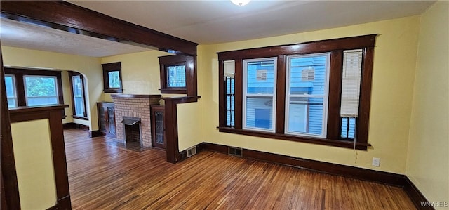 unfurnished living room featuring hardwood / wood-style floors and a fireplace