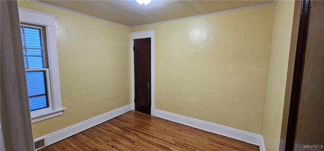 unfurnished room with ornamental molding and hardwood / wood-style floors